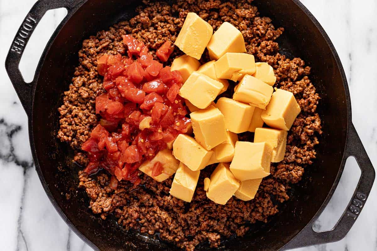 Cast iron skilled with taco meat, Rotel tomatoes, and diced Velveeta cheese. 