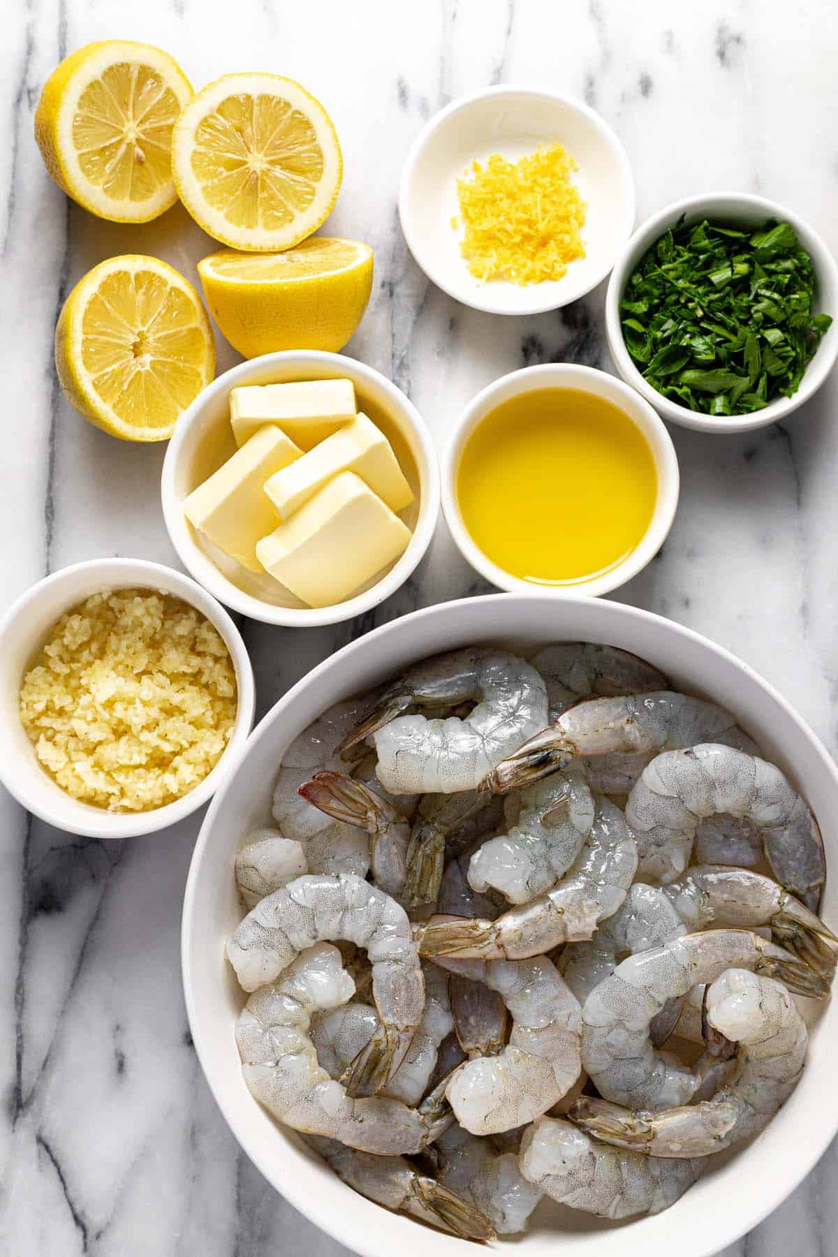Bowls of ingredients to make garlic butter shrimp. 