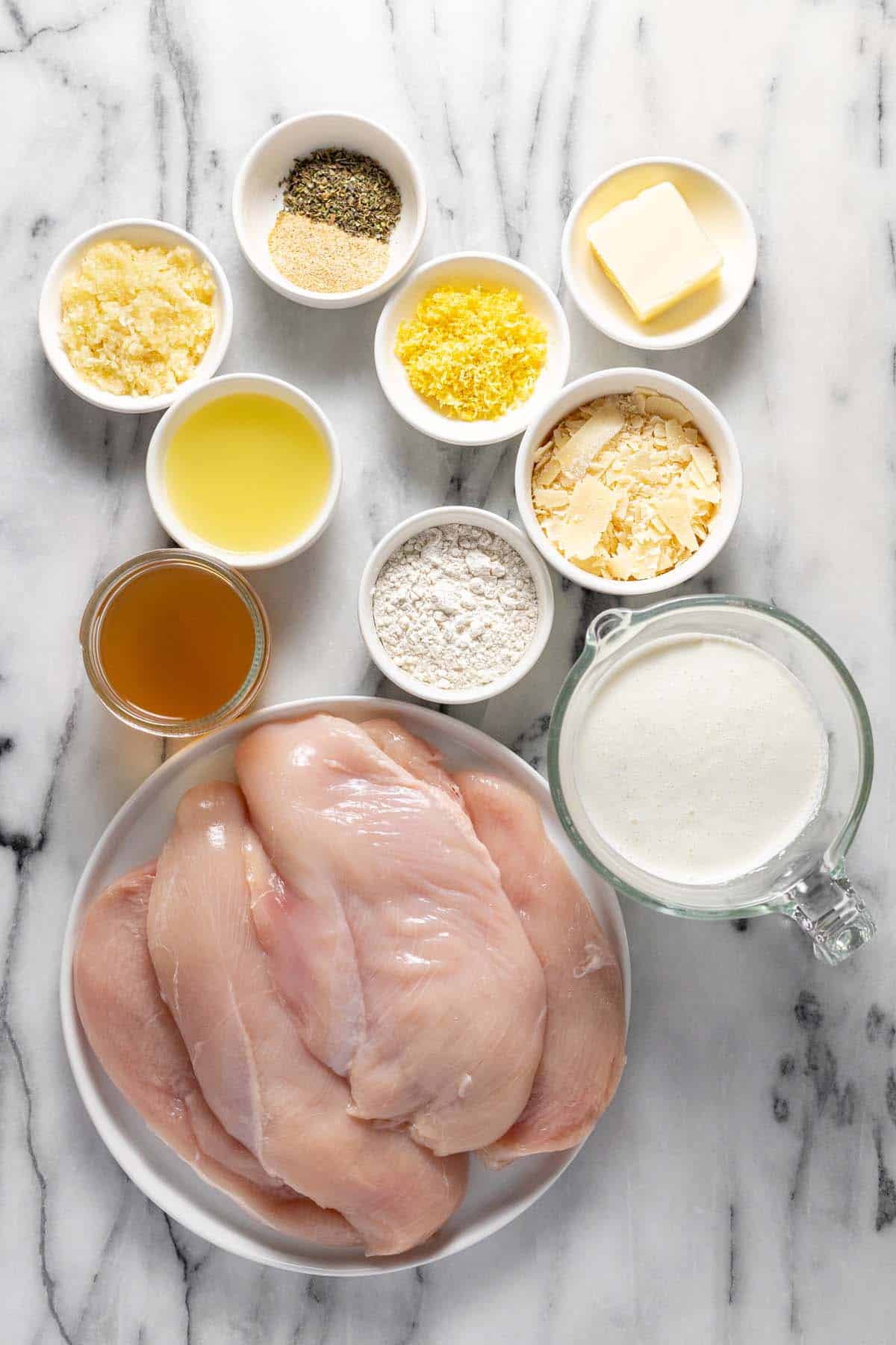 Bowls of ingredients to make creamy lemon chicken. 