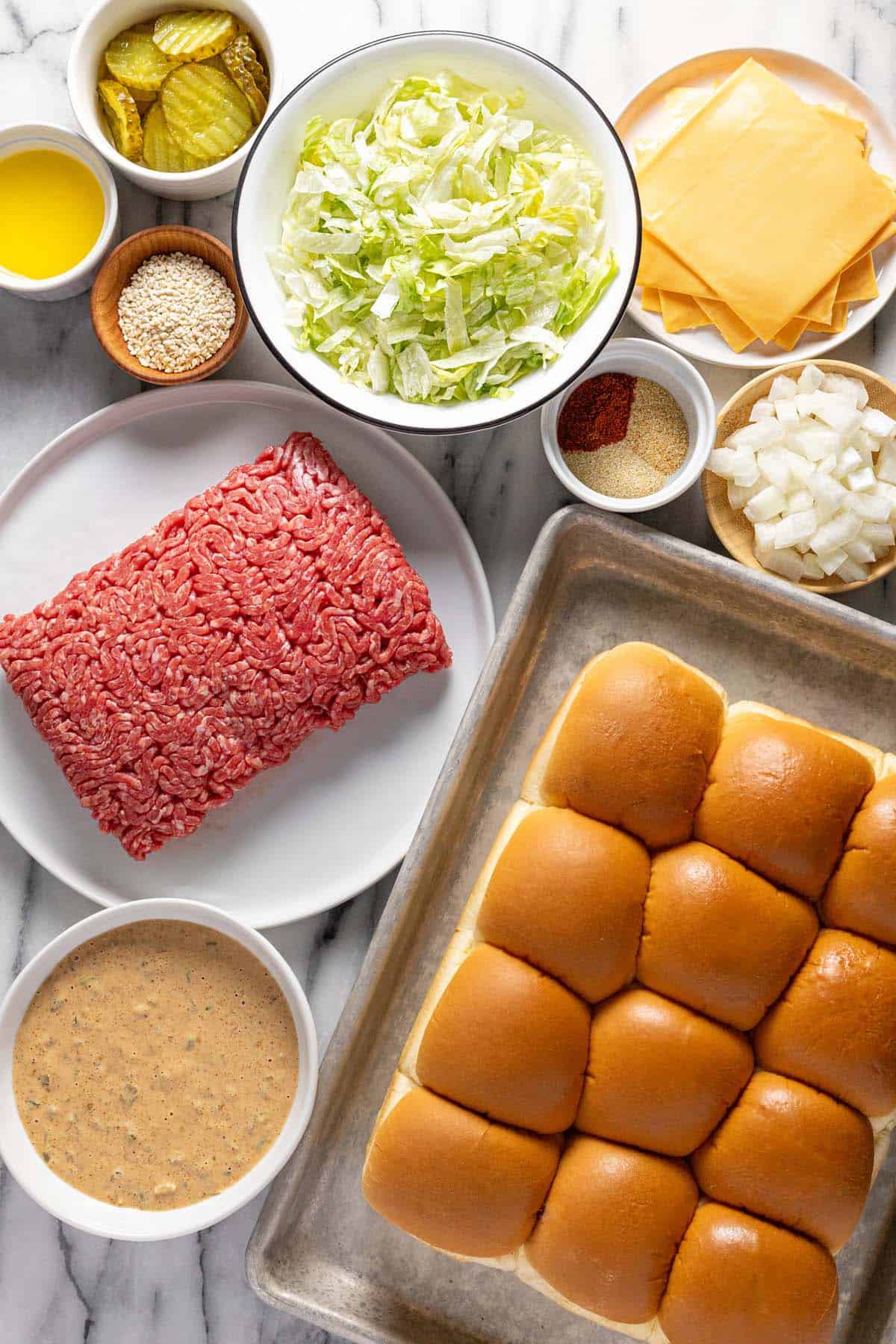 Bowls of ingredients to make Big Mac sliders. 