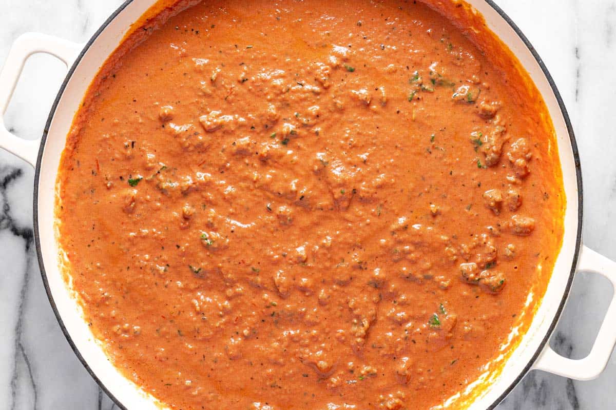 Creamy Italian sausage pasta sauce in a large pan. 