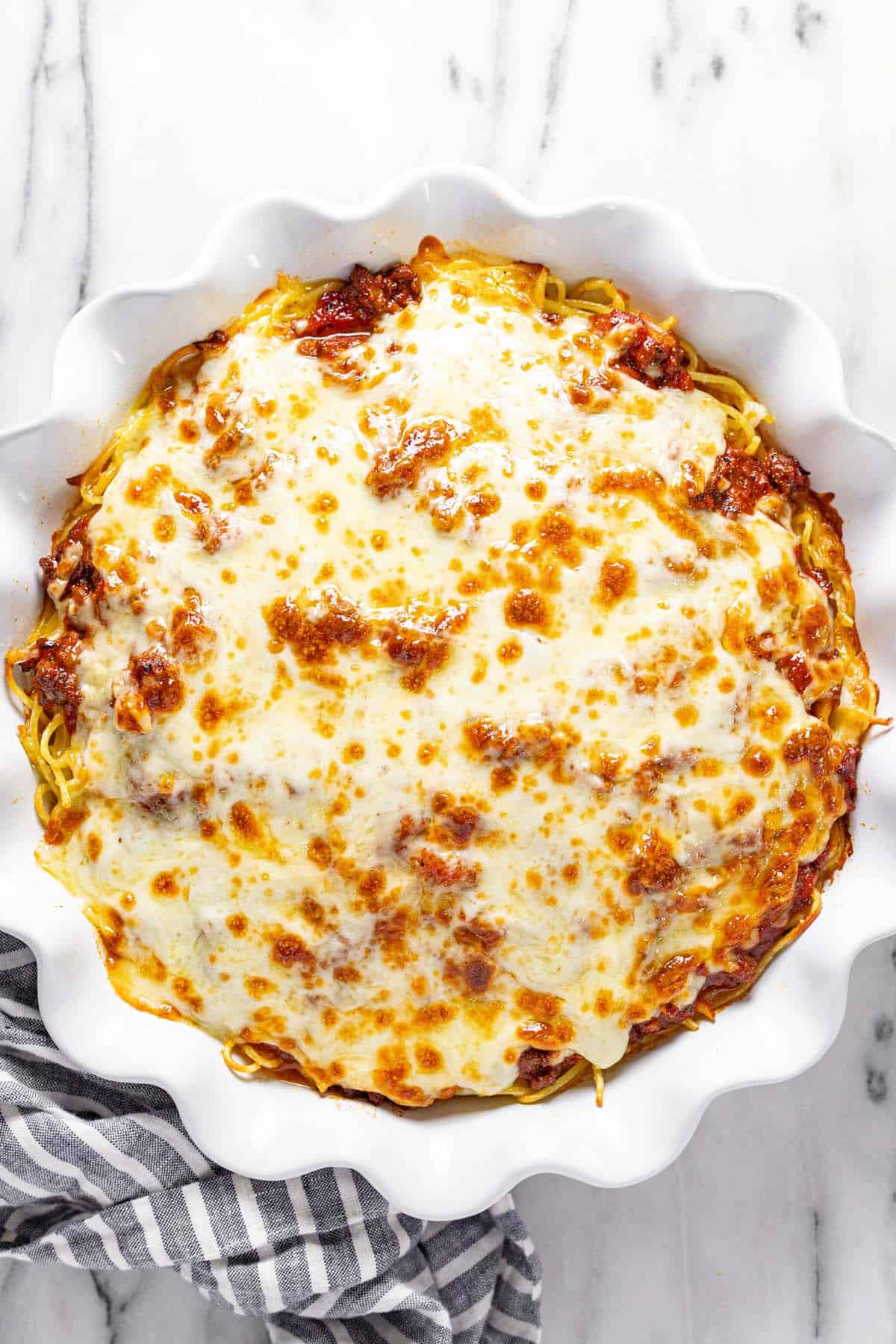Large pie pan filled with homemade spaghetti.