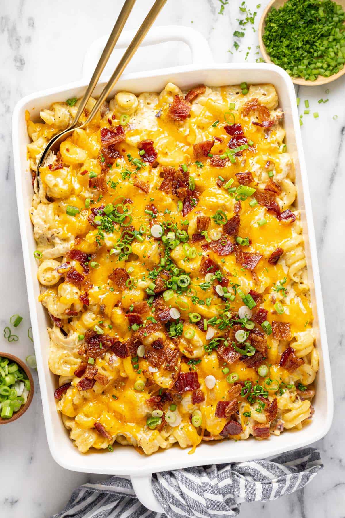 Large baking dish filled with homemade chicken bacon ranch casserole topped with green onions. 