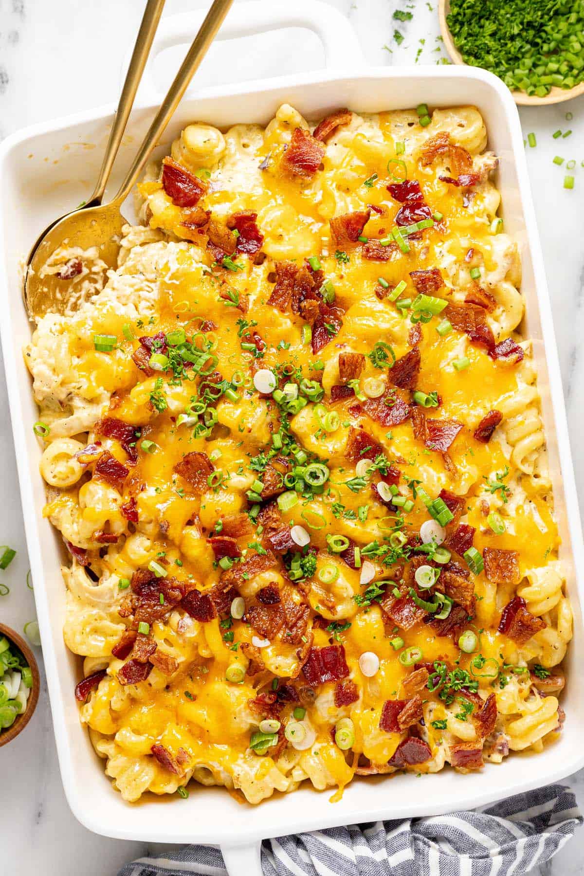 Large baking dish filled with homemade chicken bacon ranch casserole topped with green onions. 