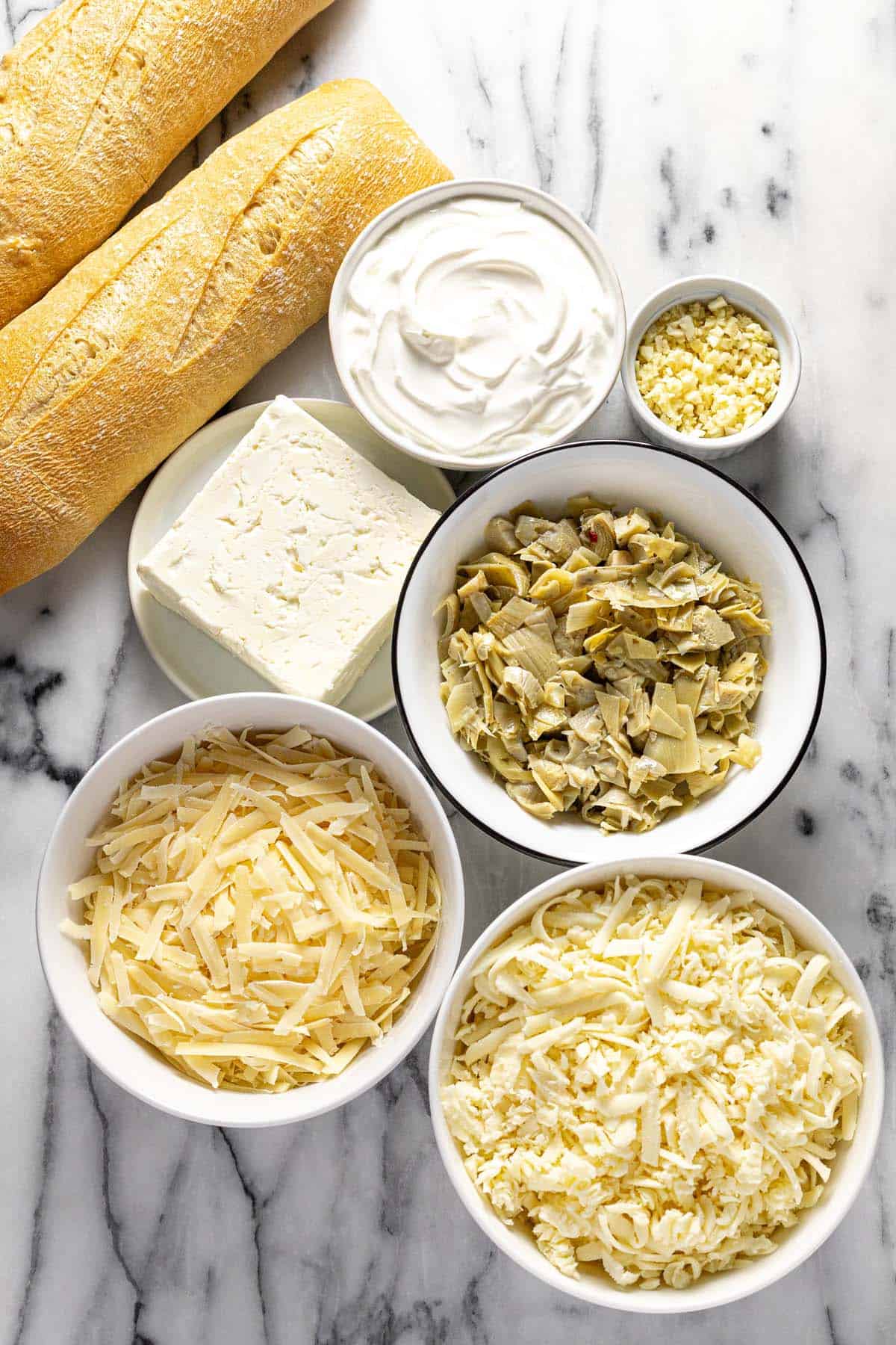 Bowls of ingredients to make creamy baked feta dip. 