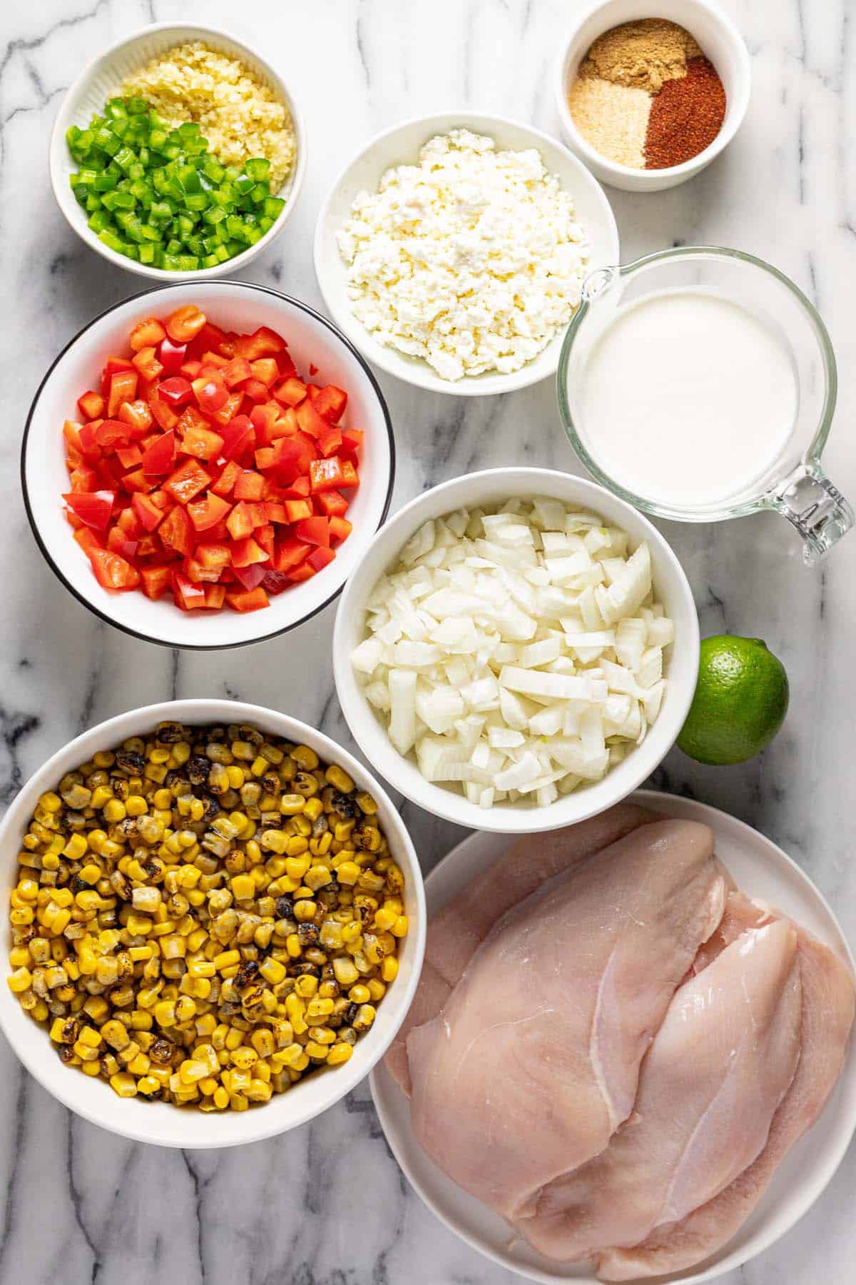 Bowls of ingredients to make street corn skillet chicken. 