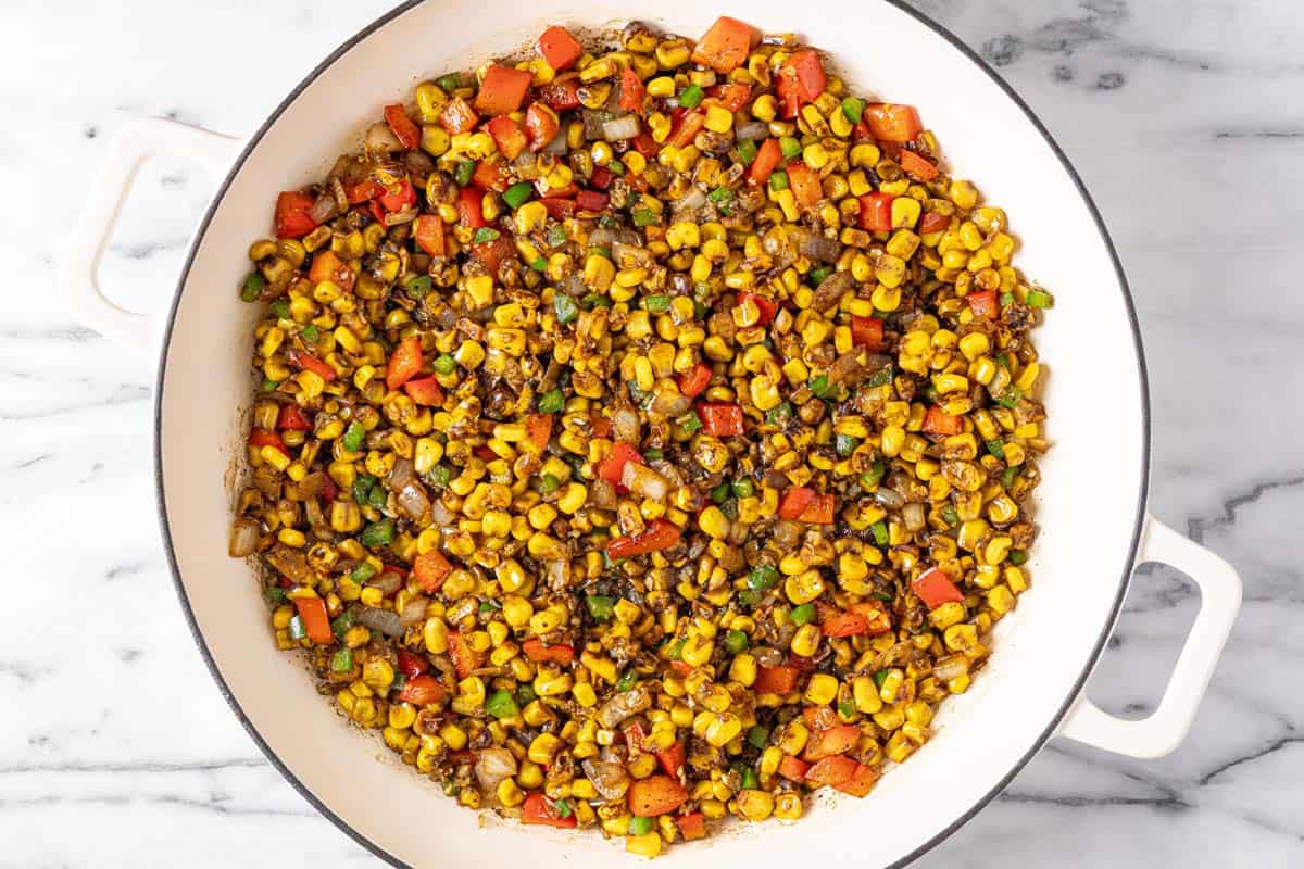 Corn, red bell pepper, jalapeno, and onion in a large saute pan. 