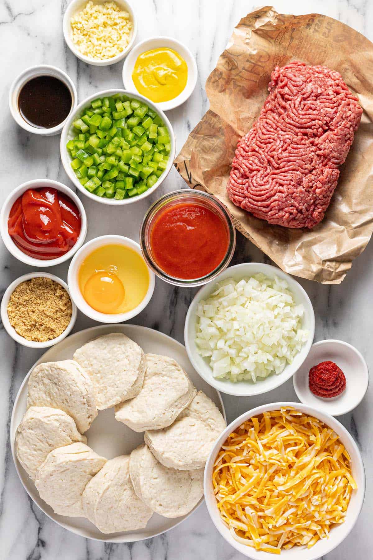 Bowls of ingredients to make homemade sloppy joe casserole. 