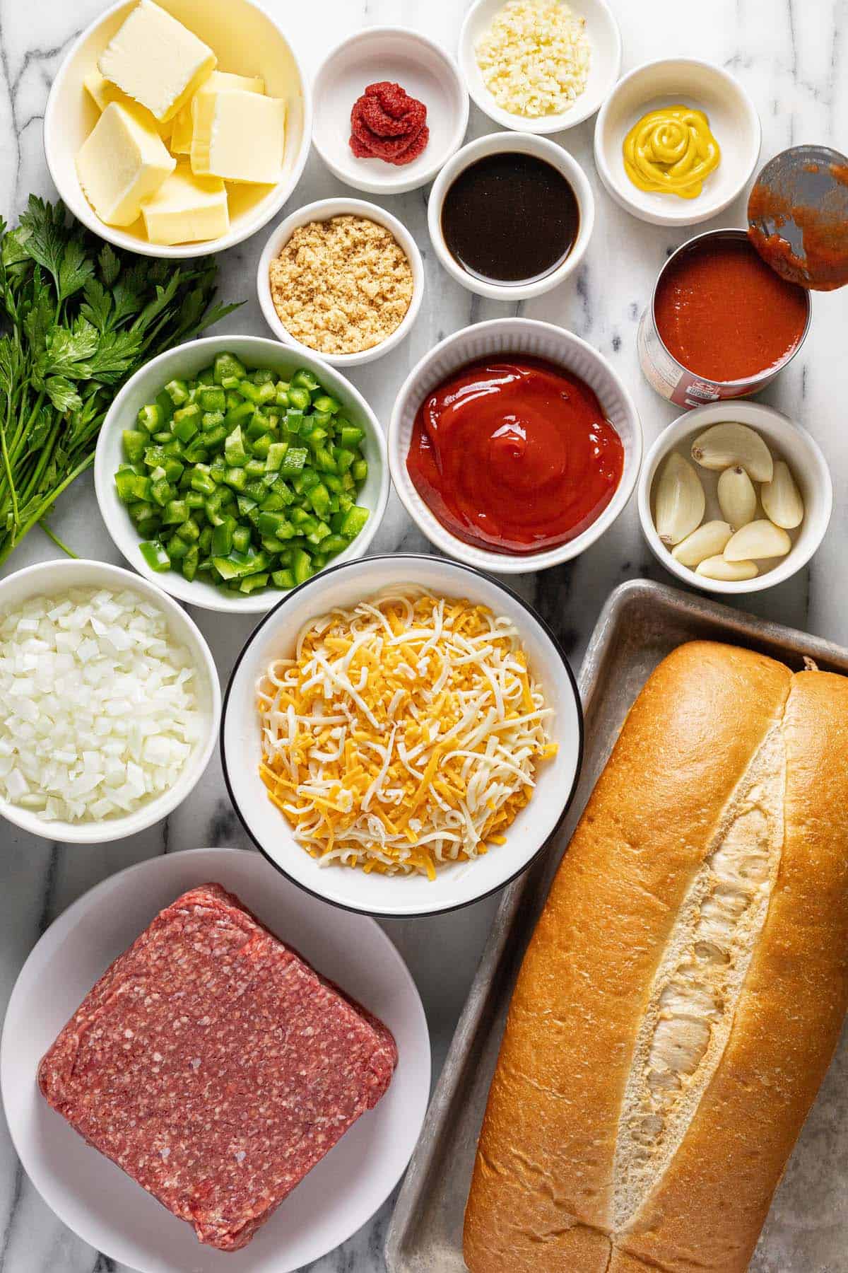 Bowls of ingredients to make sloppy joe garlic bread. 