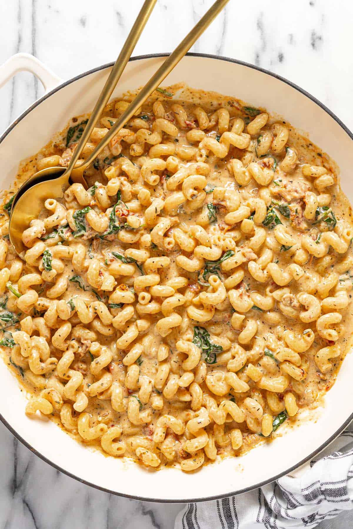 Large pan filled with sun-dried tomato pasta. 