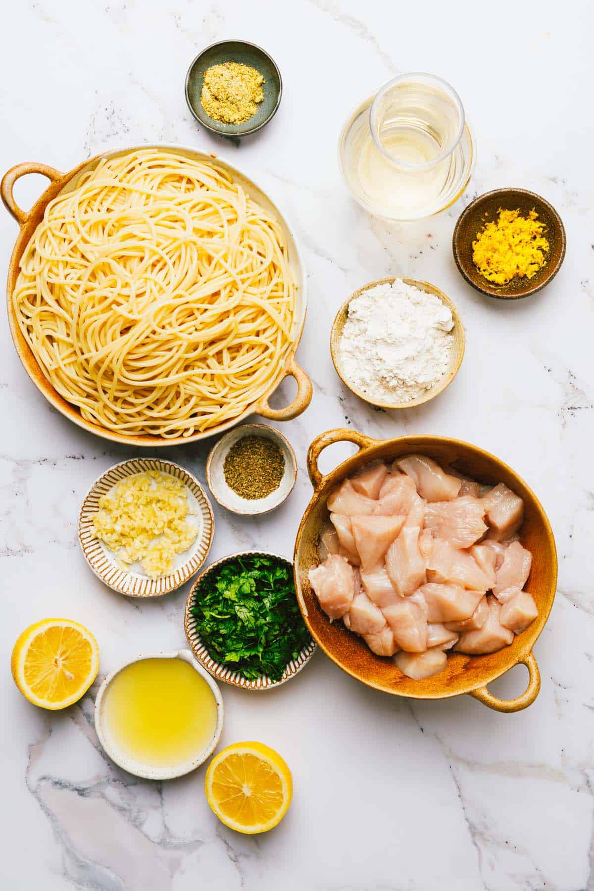 Bowls of ingredients to make chicken scampi. 