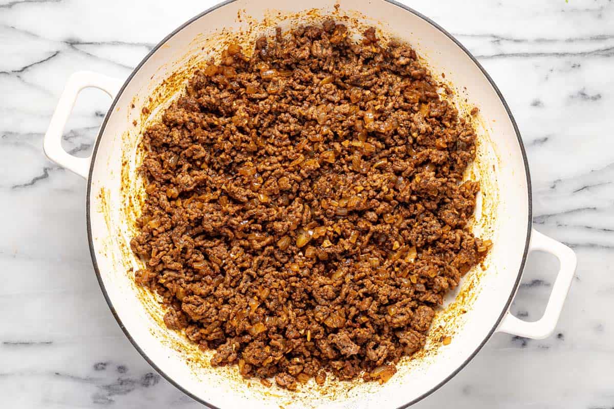 Large pan filled with seasoned ground beef and sauteed veggies. 