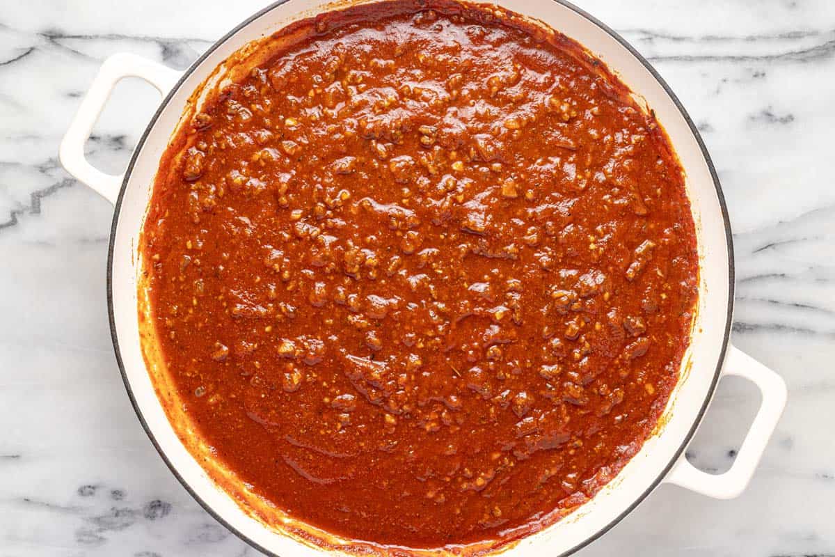 Large pan filled with homemade tomato sauce for beefaroni. 