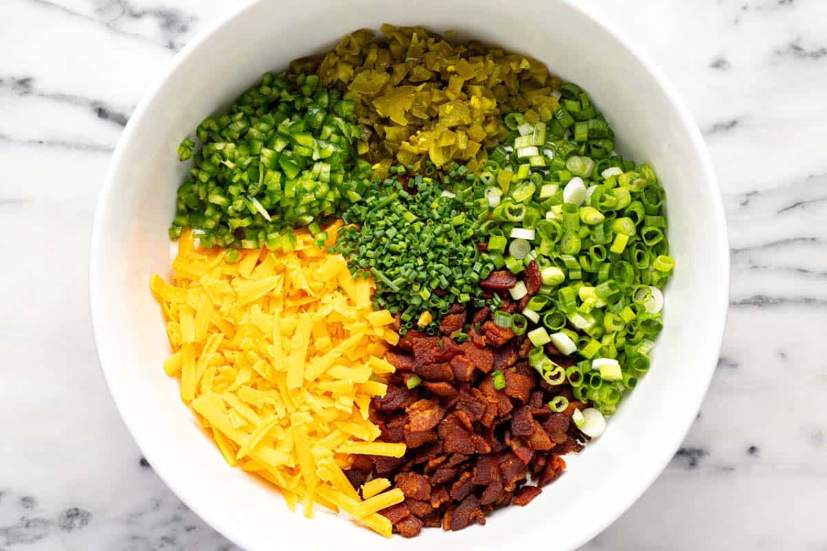 Big bowl with ingredients to make jalapeno popper dip. 