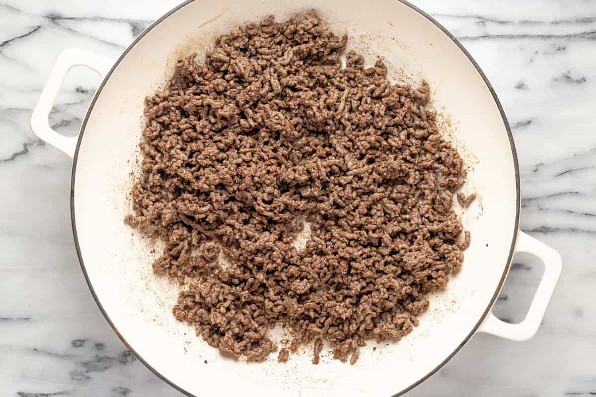 Large pan filled with ground beef. 