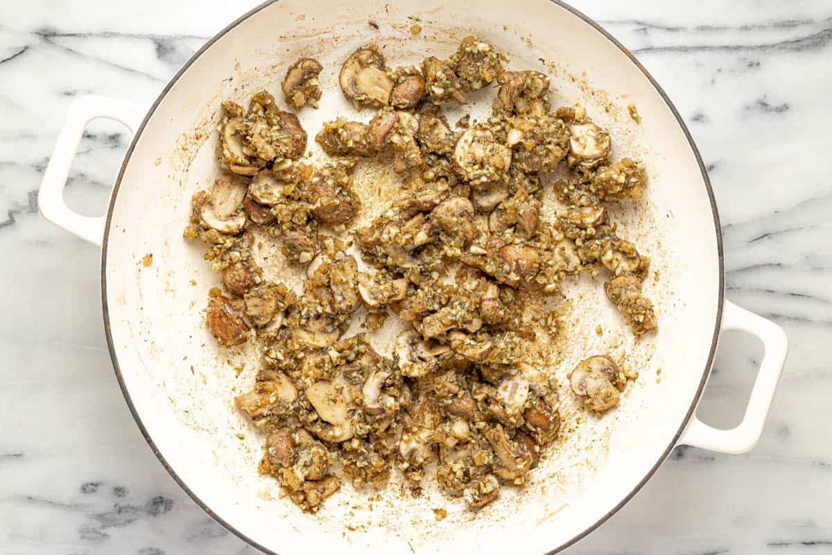 Sauteed mushrooms and onions in a large pan. 