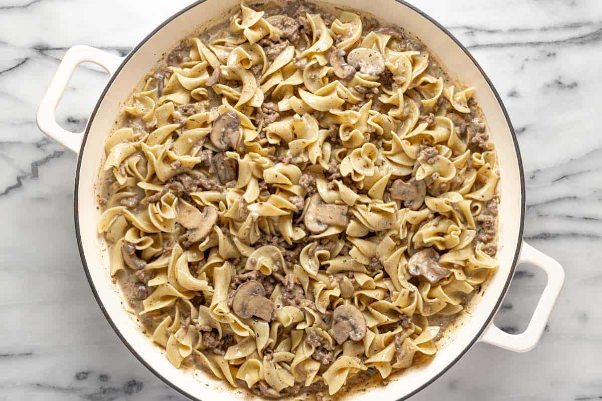 Homemade ground beef stroganoff with egg noodles in a large pan. 