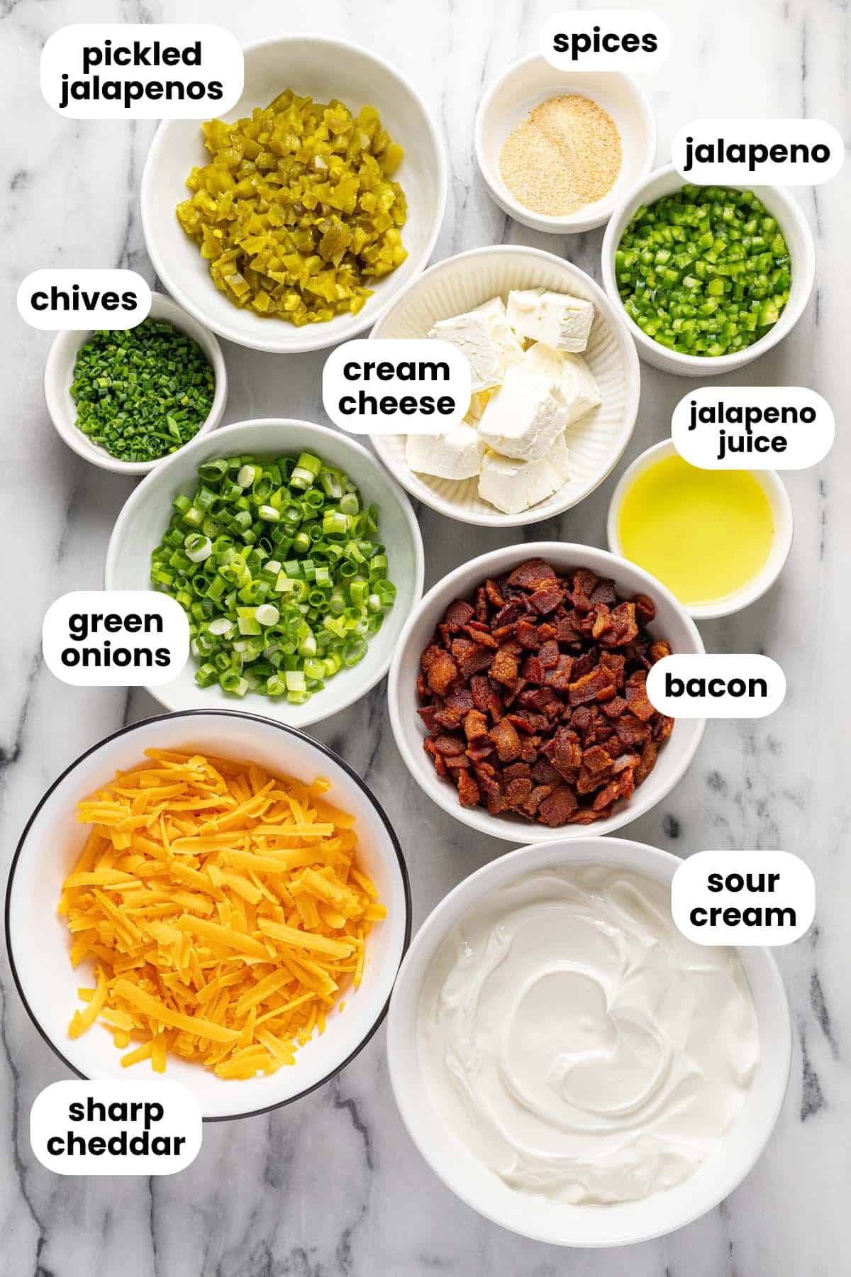 Bowls of ingredients to make cold jalapeno popper dip. 