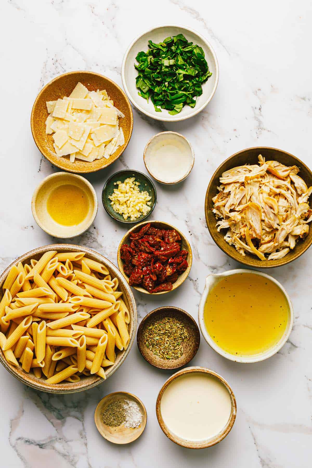 Bowls of ingredients to make marry me chicken pasta. 