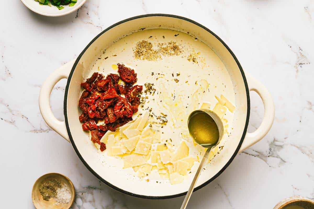 Large pot with ingredients to make marry me chicken cream sauce. 