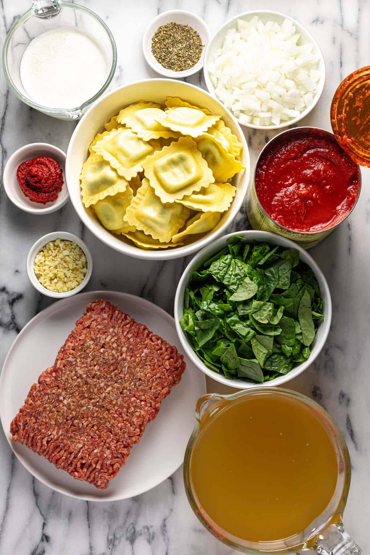 Bowls of ingredients to make ravioli soup. 