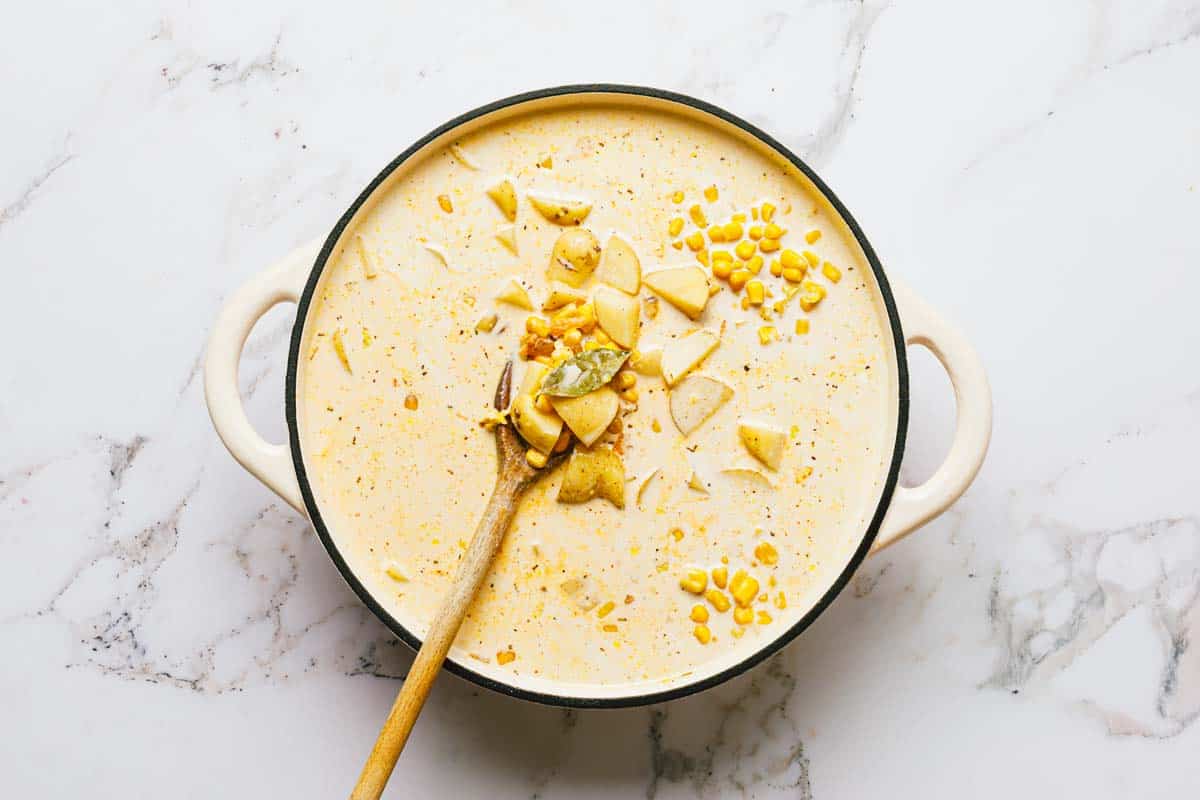 Corn, potatoes, cream, broth, and ingredients to make corn and potato chowder. 