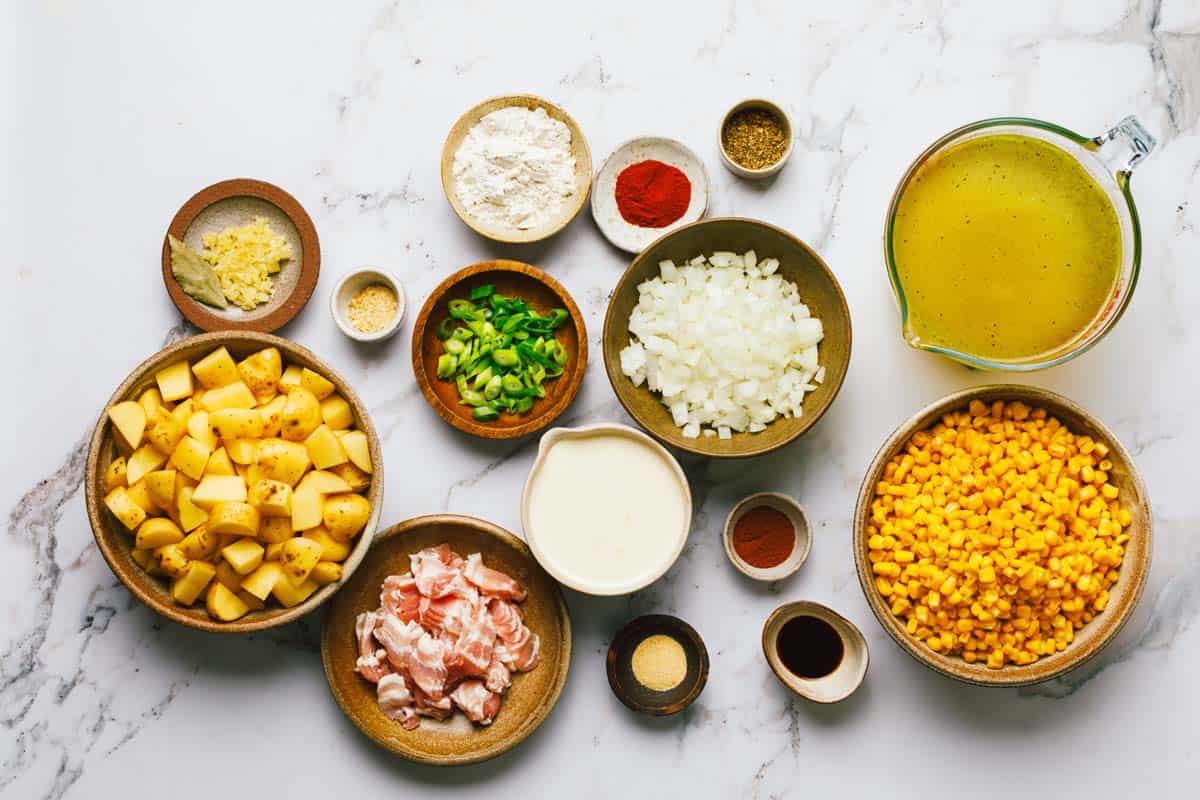 Bowls of ingredients to make corn and potato chowder. 