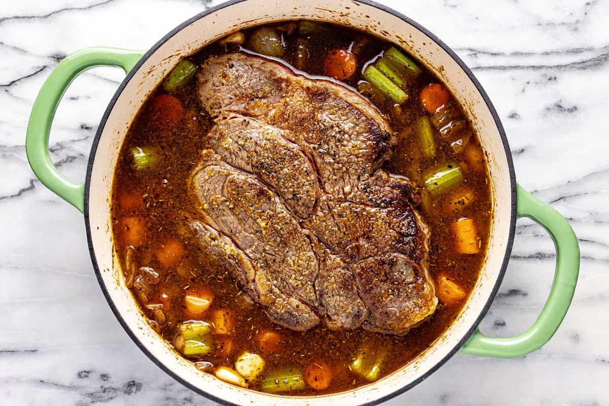 Seared beef chuck roast with satueed veggies in broth. 