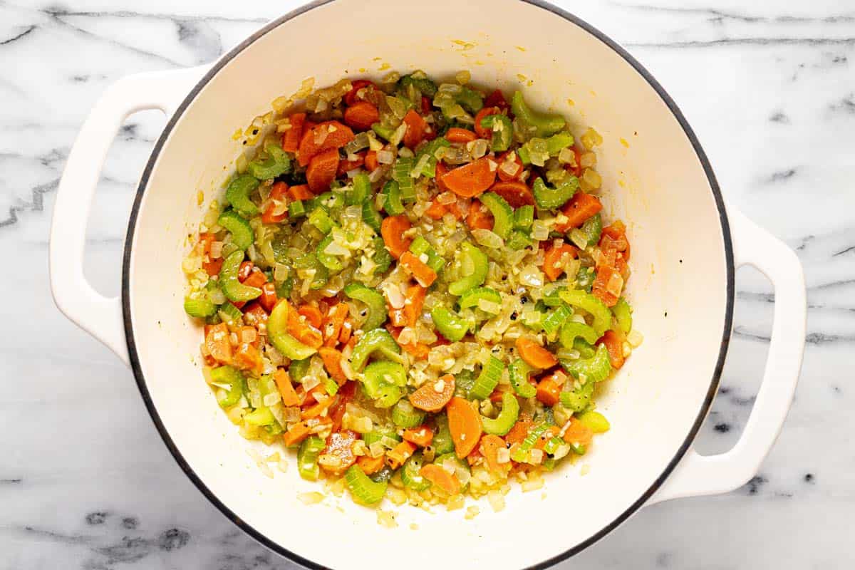 Large pot filled with sauteed veggies, garlic, and herbs. 