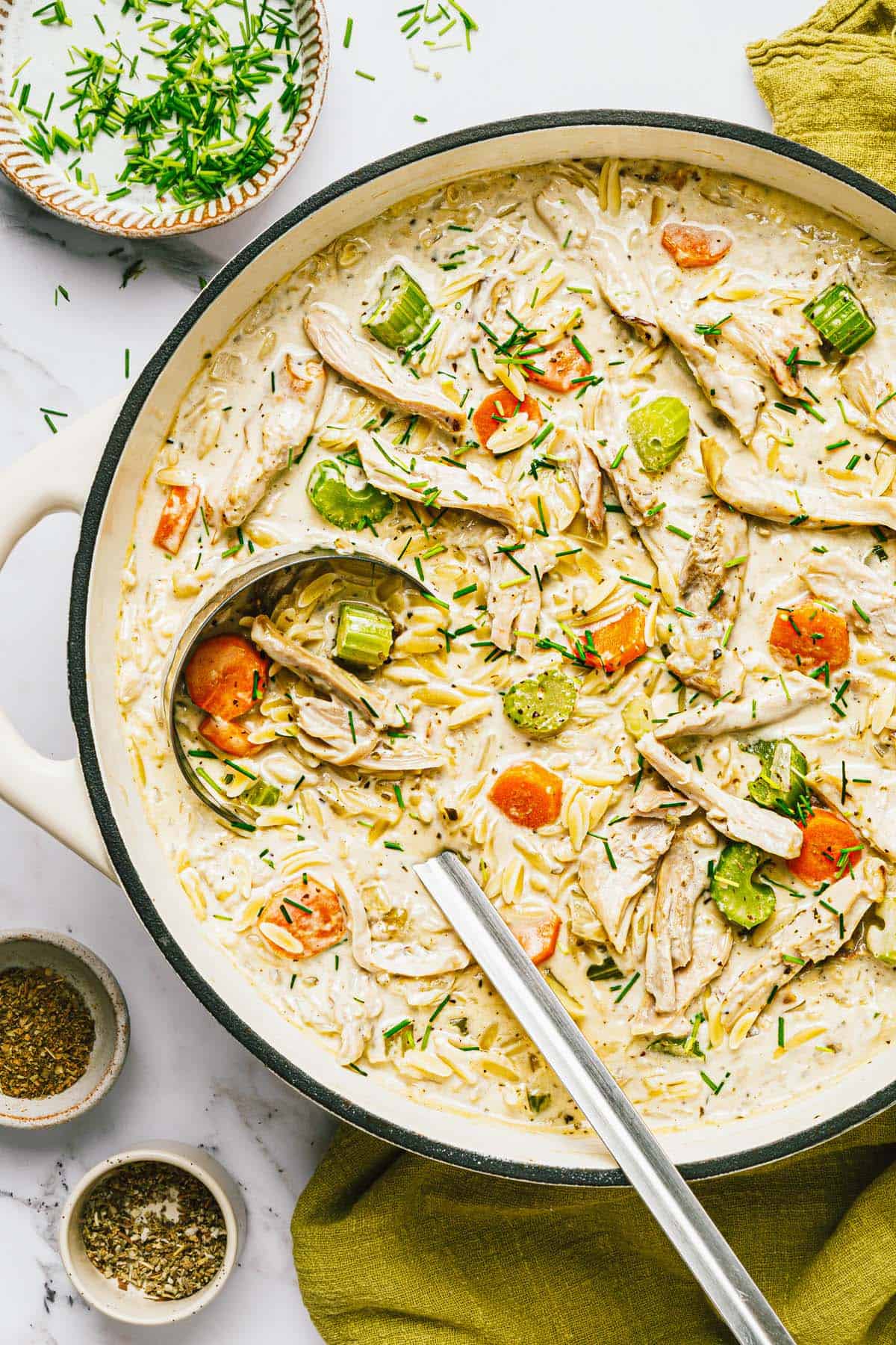 Large pot of creamy chicken and orzo soup. 