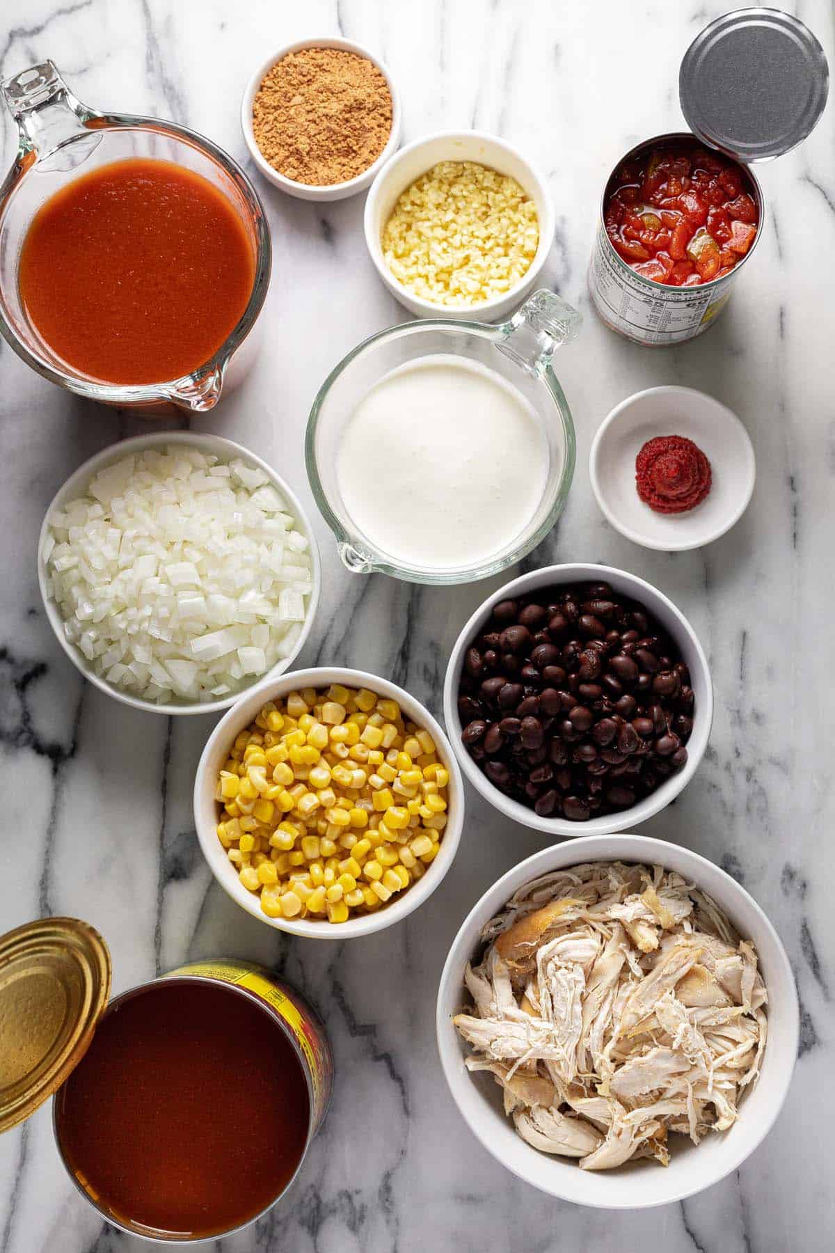 Bowls of ingredients to make creamy chicken soup. 