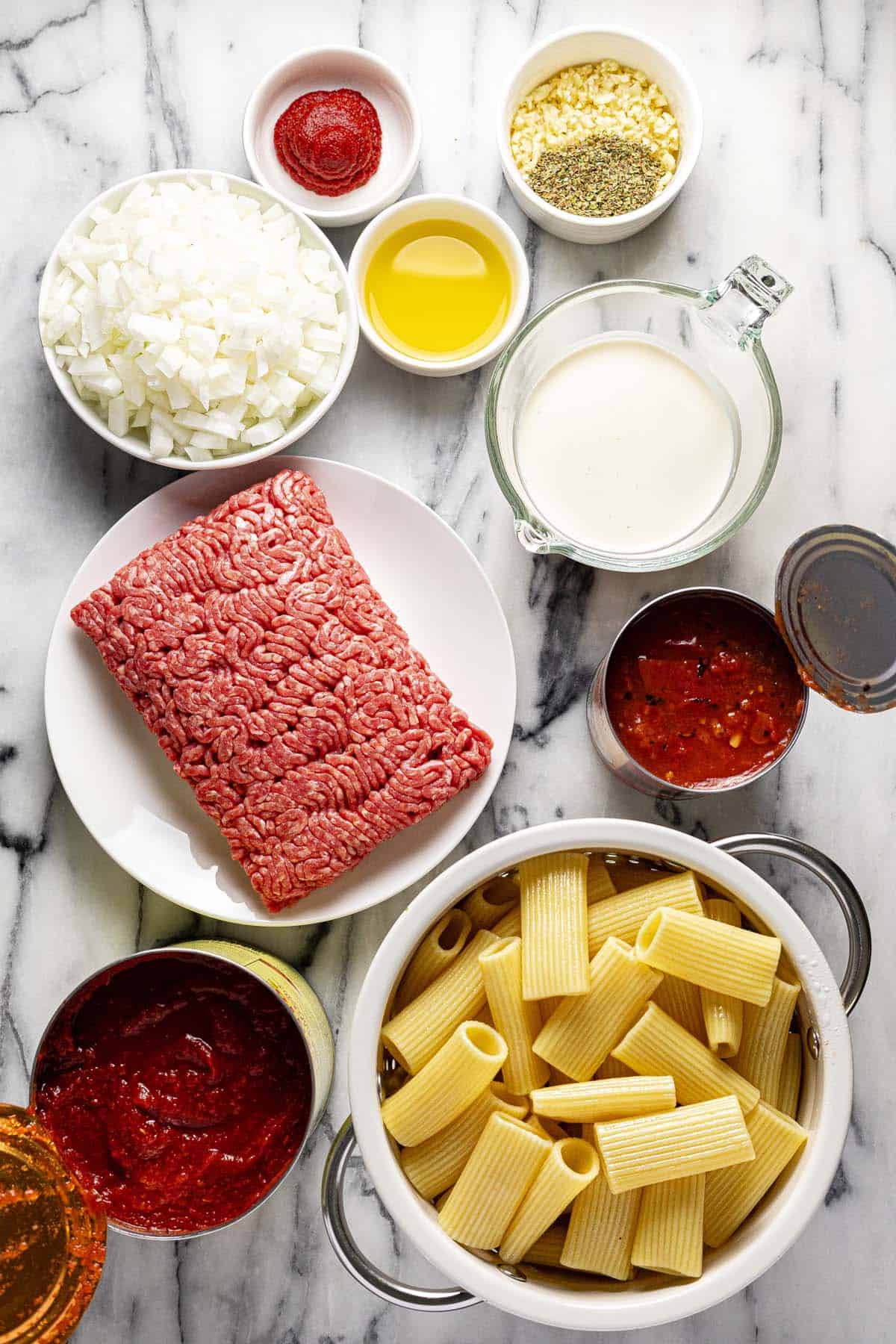 Bowls of ingredients to make ground beef pasta. 