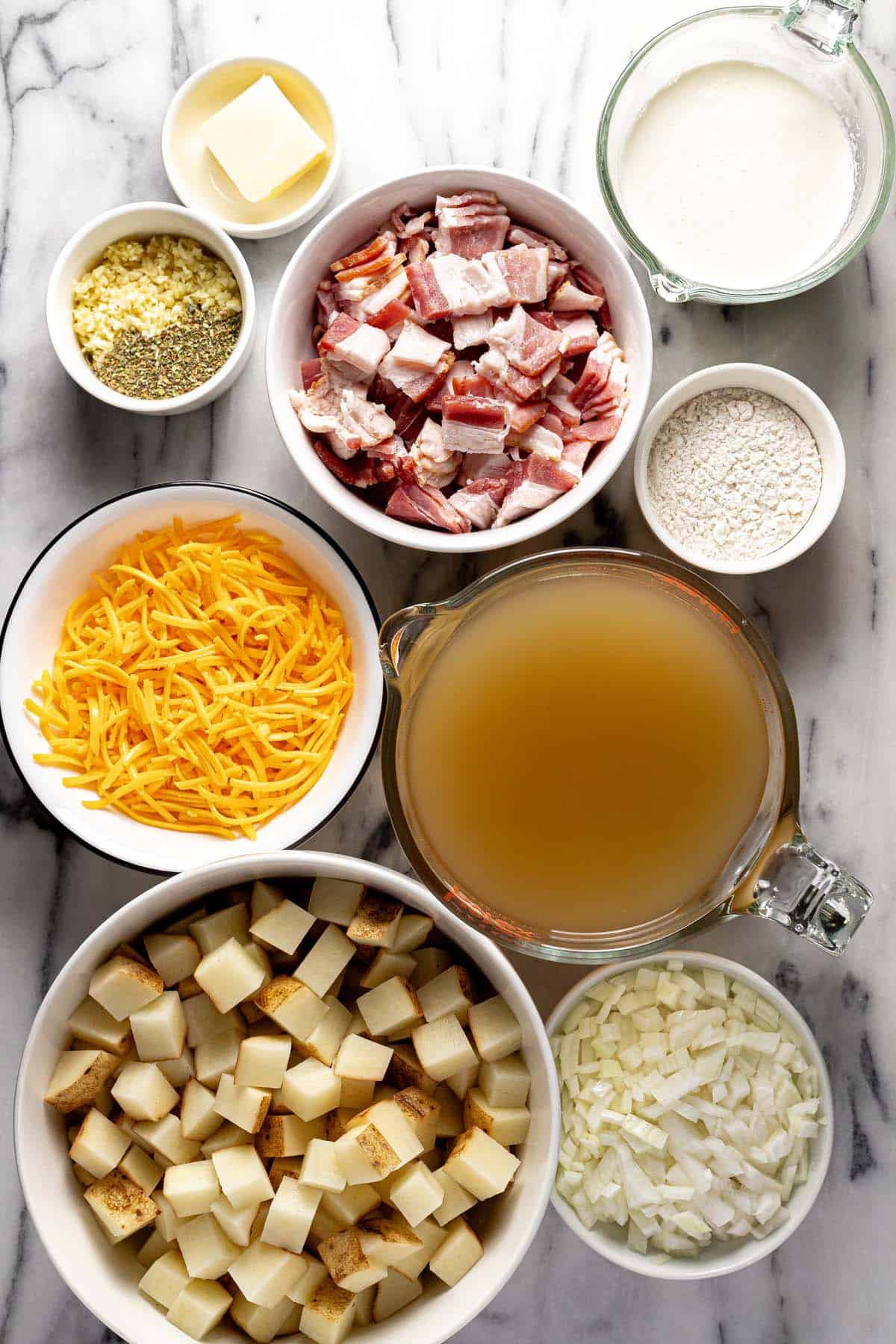 Bowls of ingredients to make homemade loaded baked potato soup. 