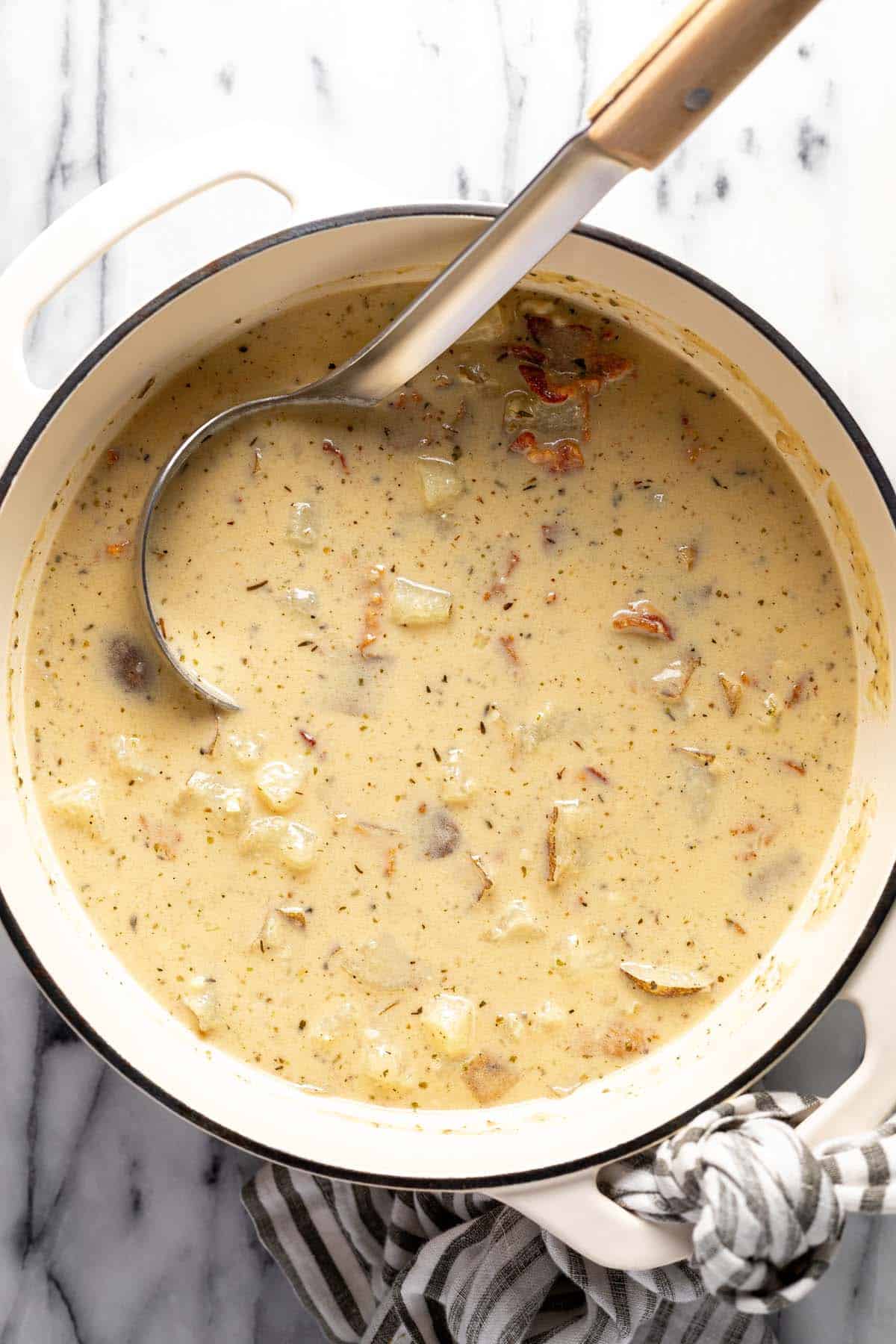 Large pot filled with homemade loaded baked ptoato soup. 