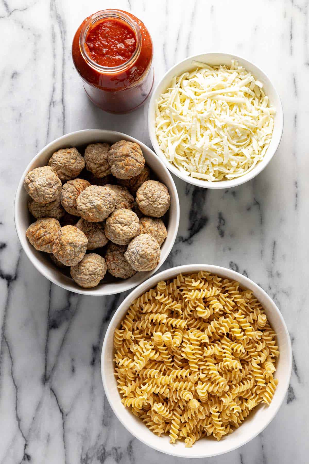 Bowls of ingredients to make homemade meatball casserole. 