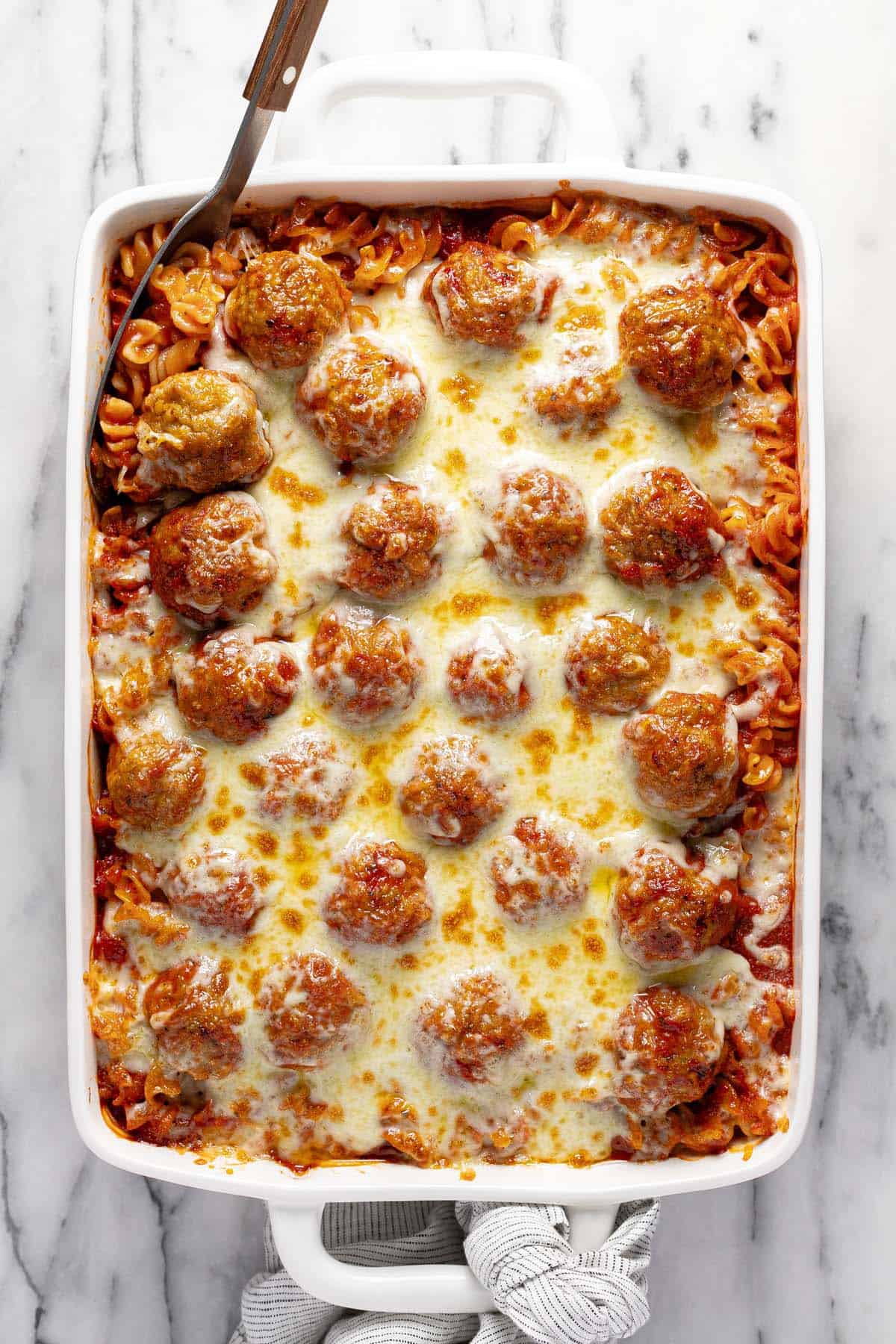 Large pan filled with homemade dump and bake meatball pasta. 