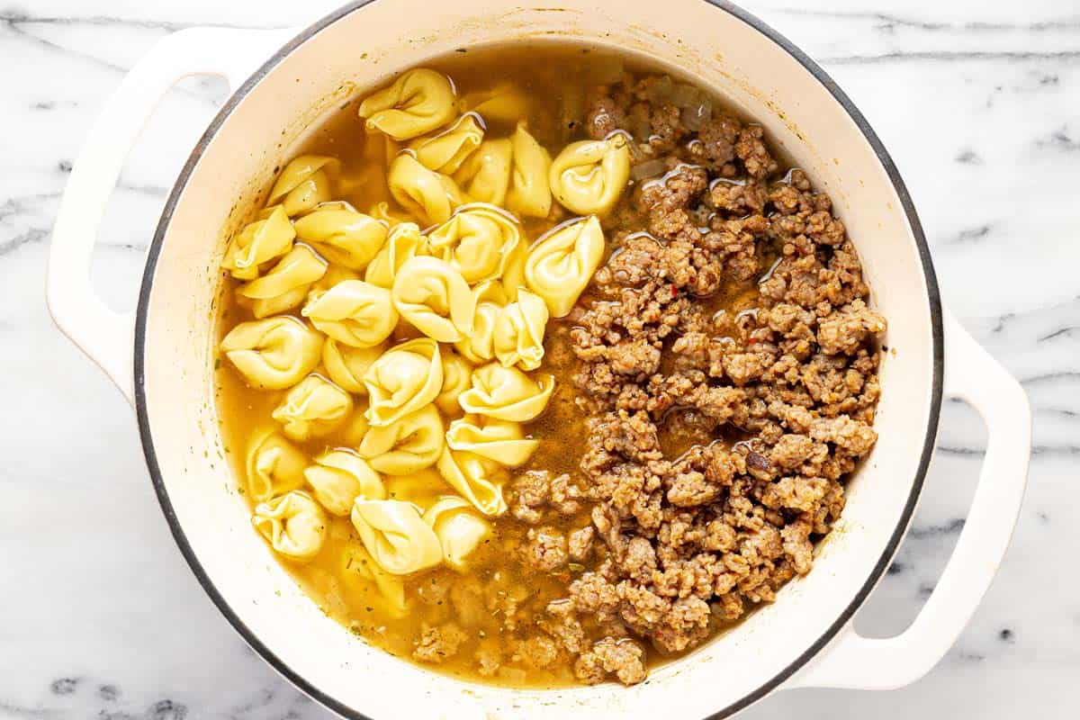 Sausage and tortellini added to a brothy soup. 