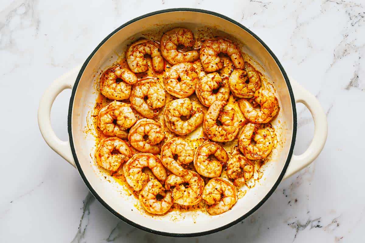 Sauteed shrimp in a large pan. 