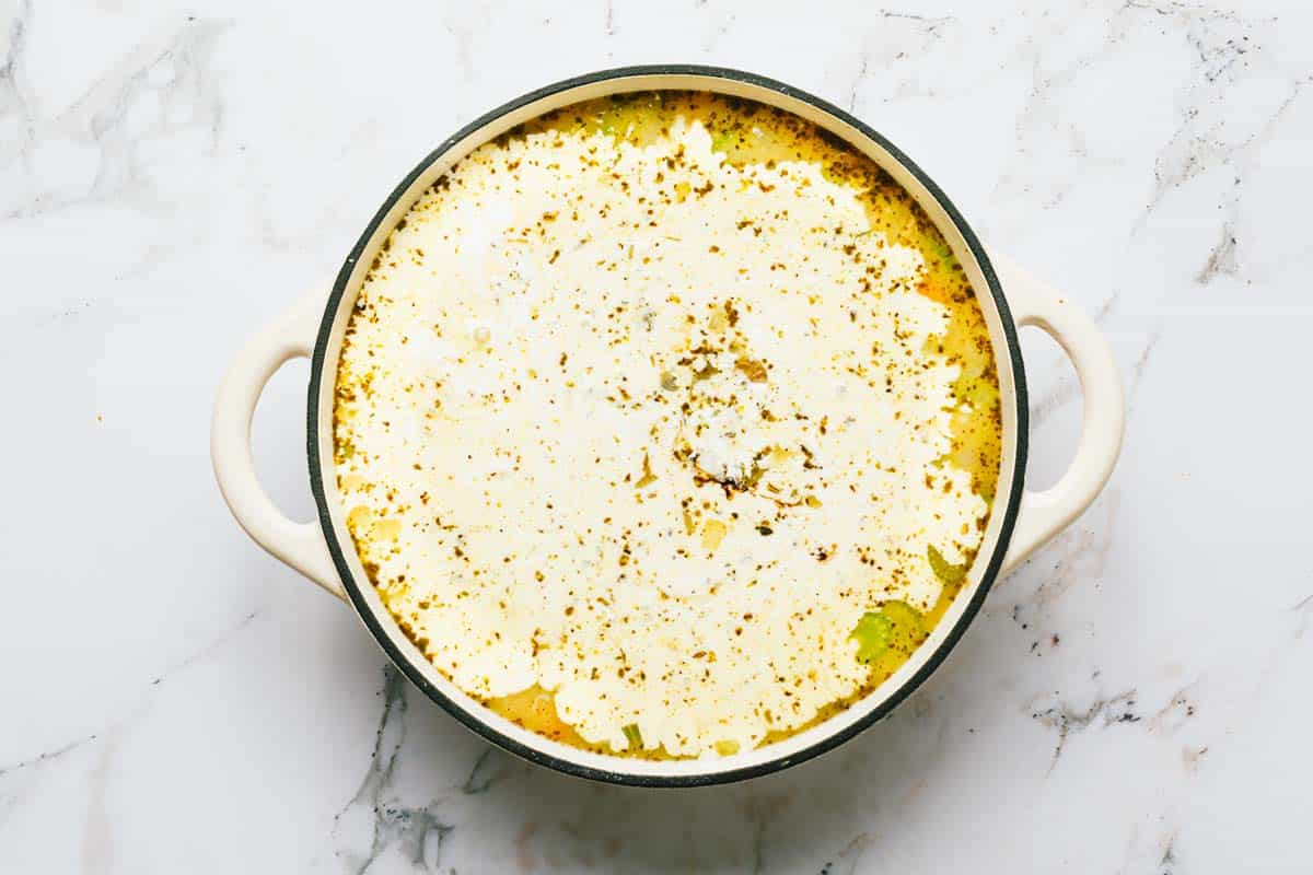 Ingredients to make creamy chicken potato soup in a large pot. 