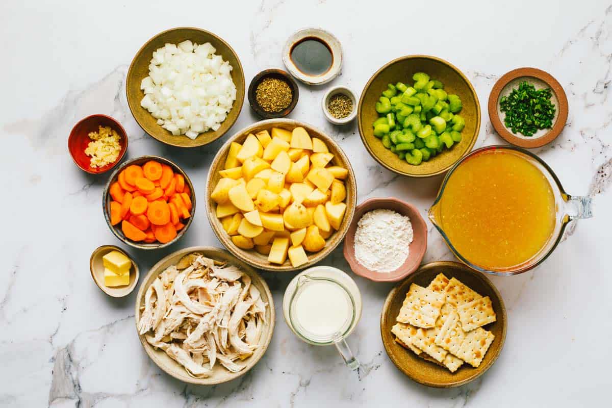 Bowls of ingredients to make creamy chicken potato soup. 