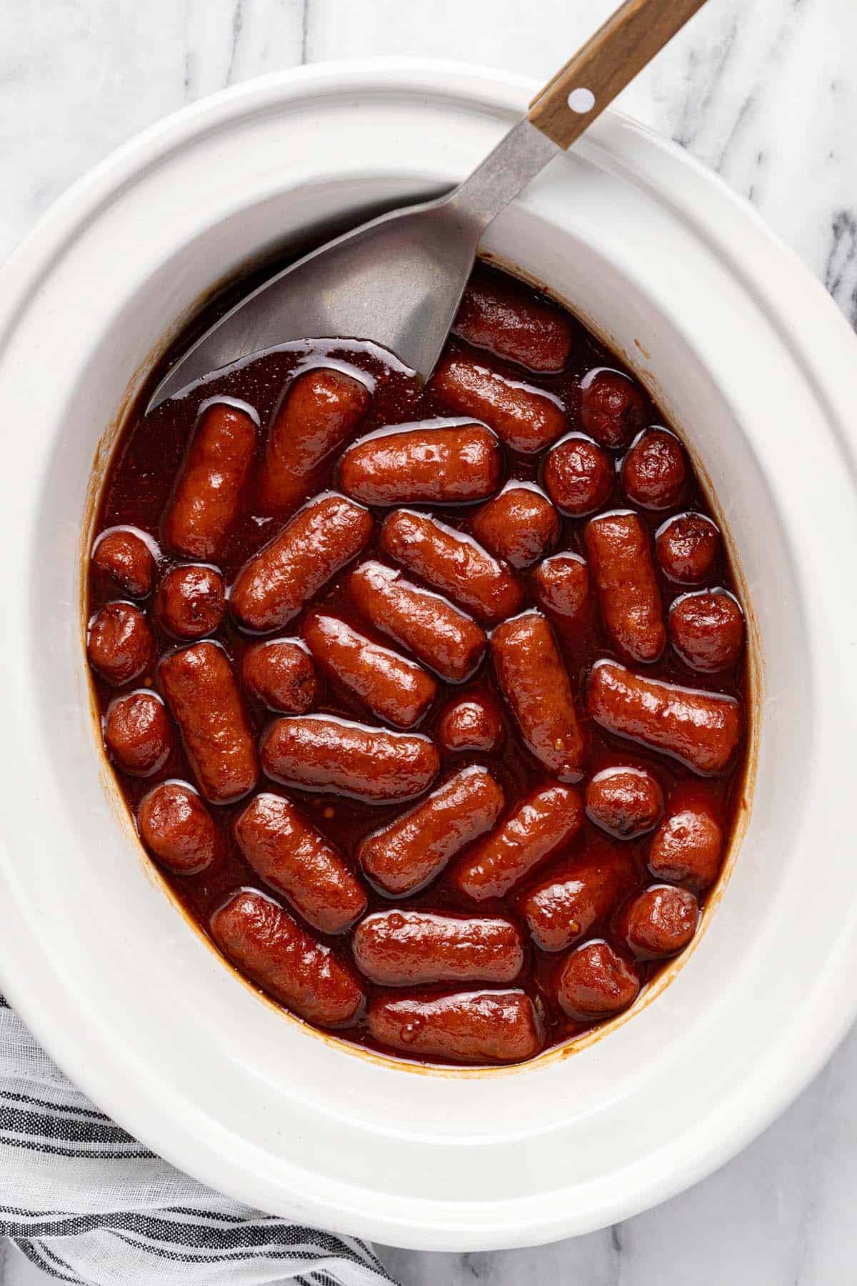 Slow cooker with lit'l smokies in cocktail sauce. 