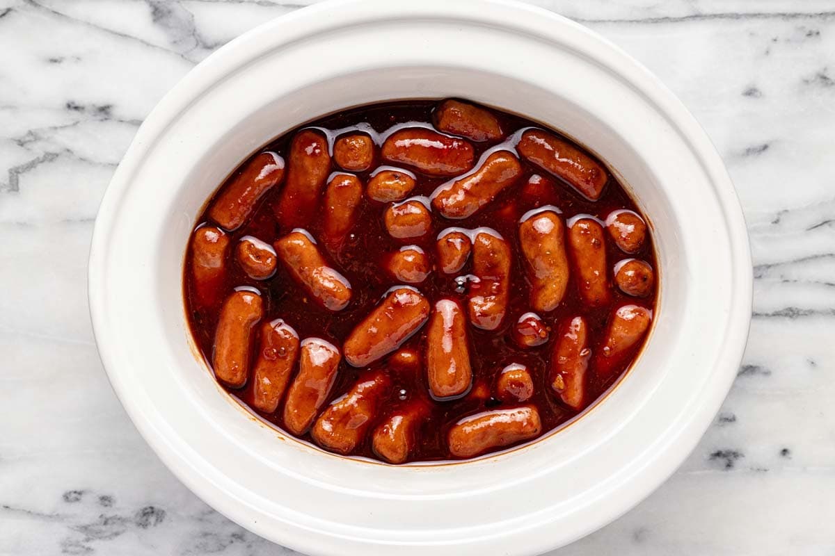 Crock pot filled with grape jelly, chili sauce, and lit'l smokies. 