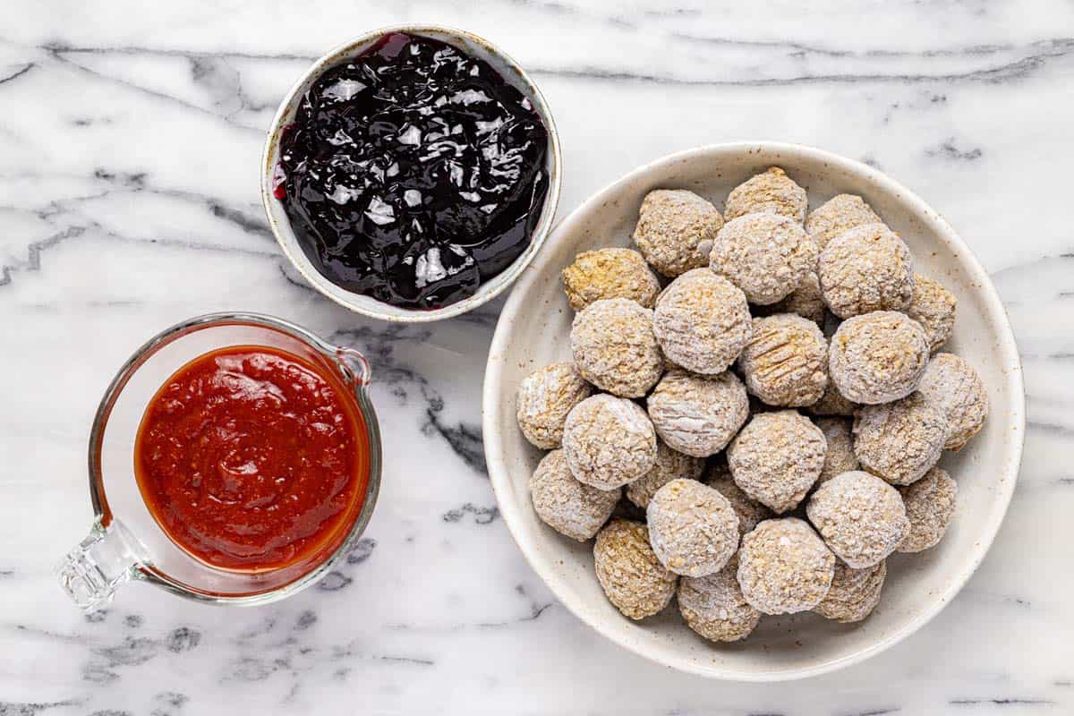 Bowls of ingredients to make meatballs with grape jelly and chili sauce. 