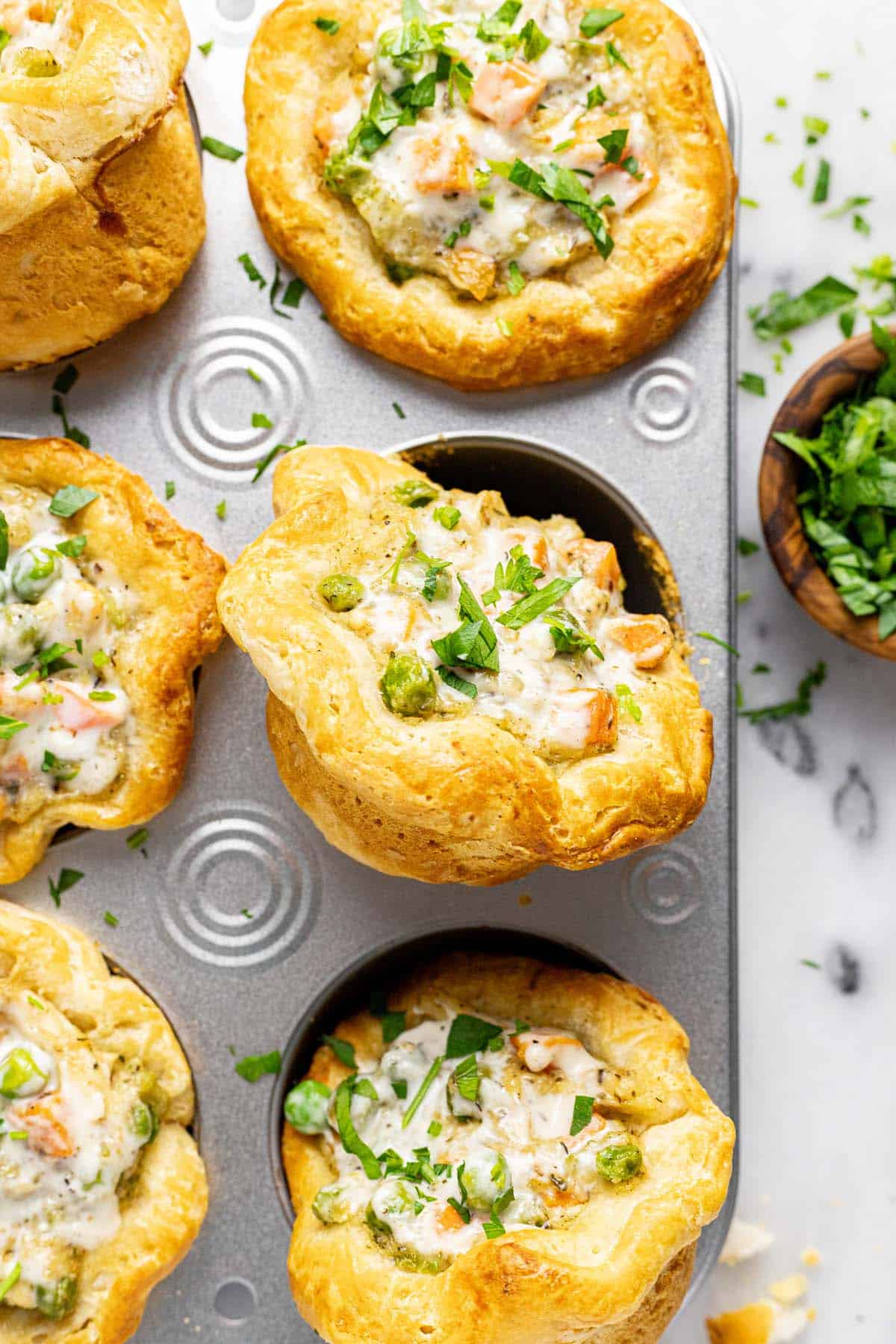 Close up shot of a mini pot pie in a muffin tin. 