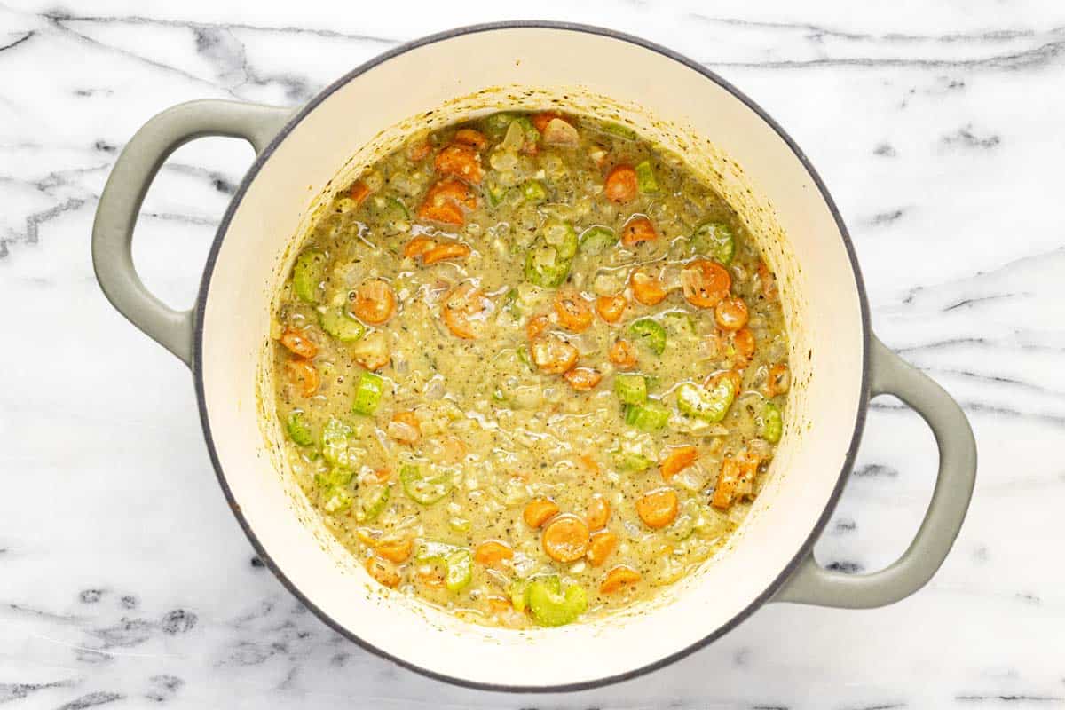 Large pot filled with sauteed veggies in a roux. 