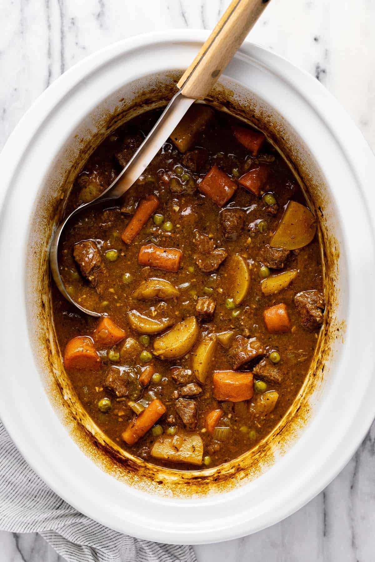 Homemade crockpot beef stew in a slow cooker insert. 