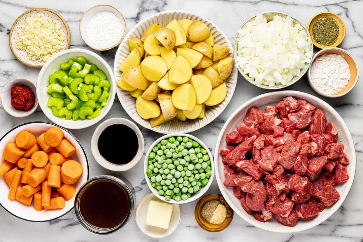 Bowls of ingredients to make slow cooker beef stew. 