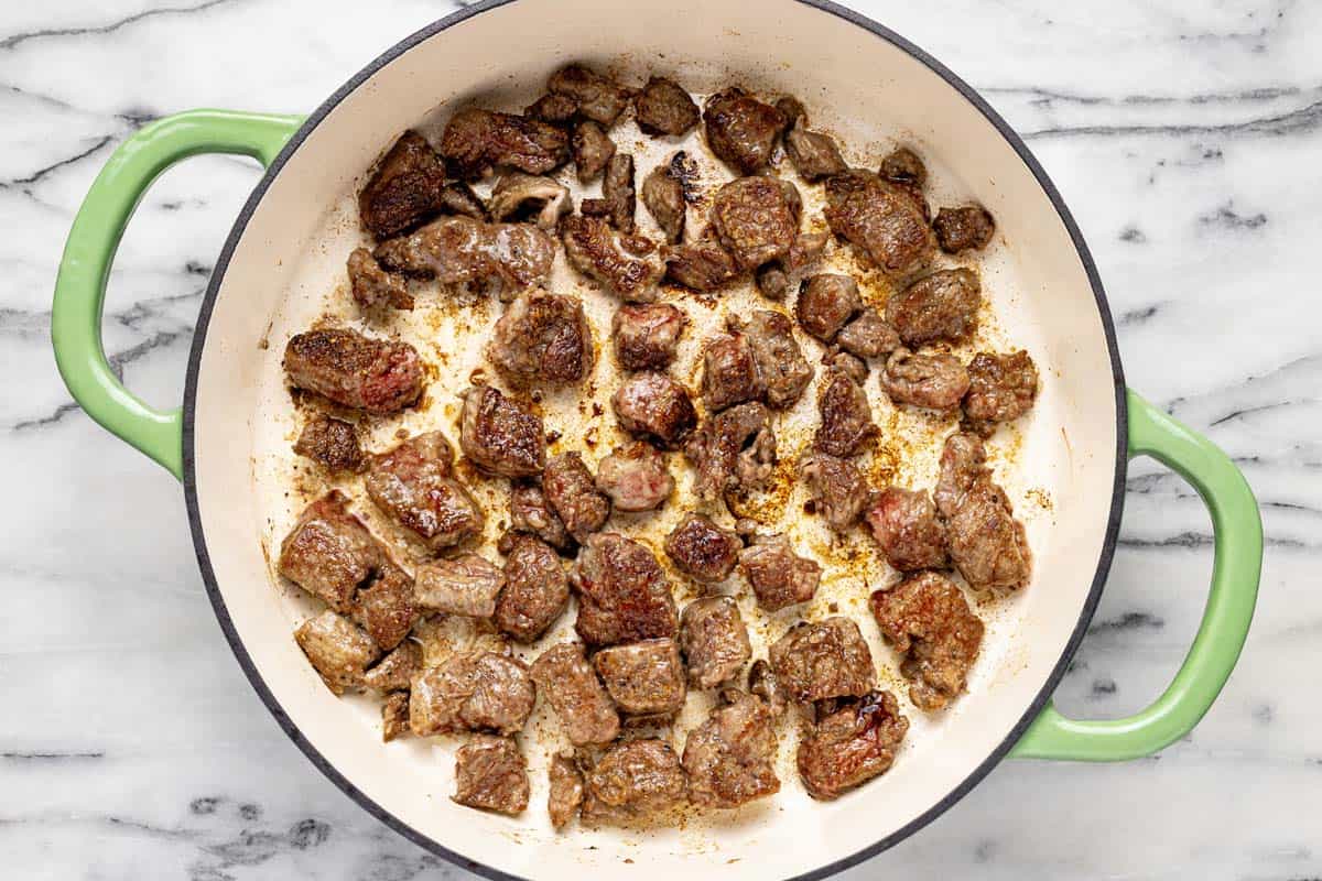 Seared beef in a large pan. 