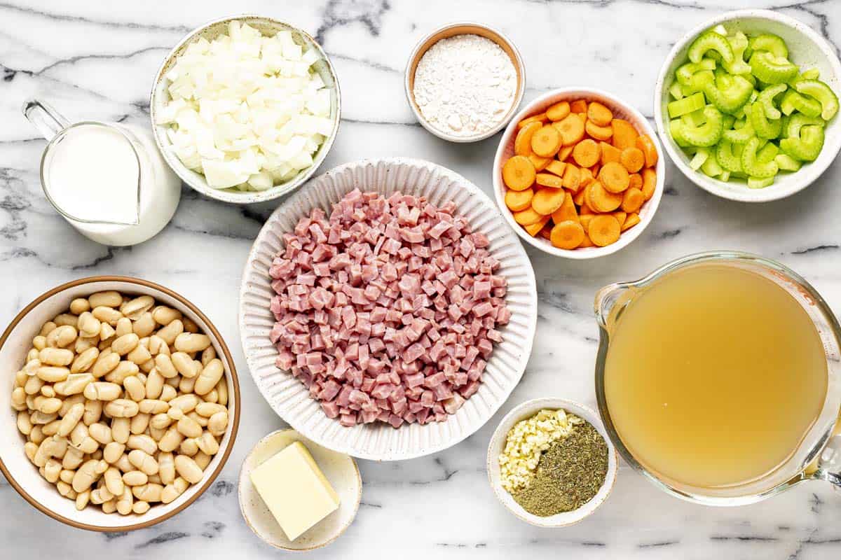 Bowls of ingredients to make white bean and ham soup. 