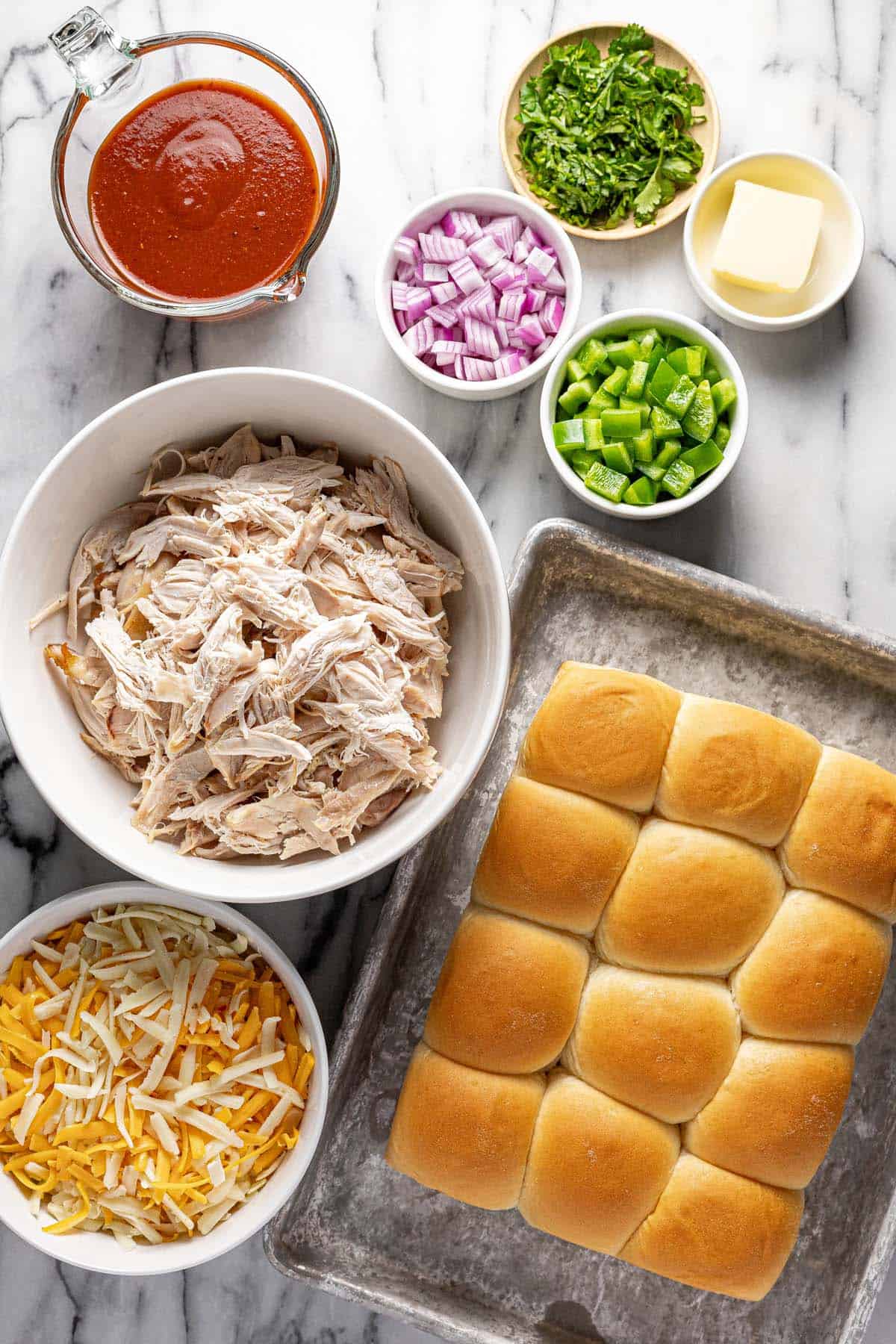 Bowls of ingredients to make BBQ chicken sliders. 